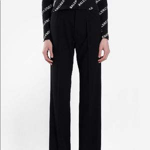 BALENCIAGA BLACK WOOL FLARE PANTS .